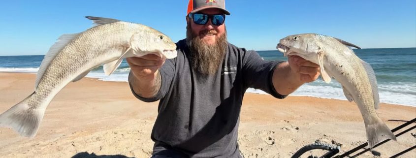 Ian from Tug Trash Outdoors carrying multiple fishing rods across a Florida beach using the Rod-Runner Portable Fishing Rod Caddy.